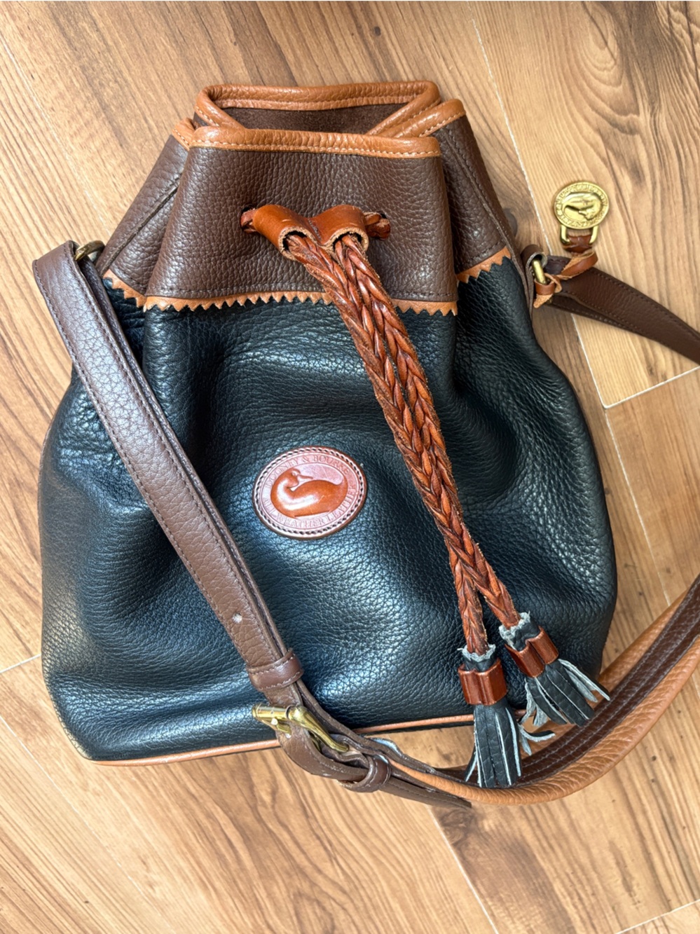 Dooney & Bourke Black with Brown Trim Leather Drawstring Bucket Bag